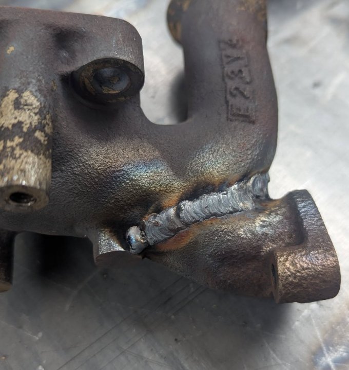Finished weld repair on a cracked cast iron exhaust manifold